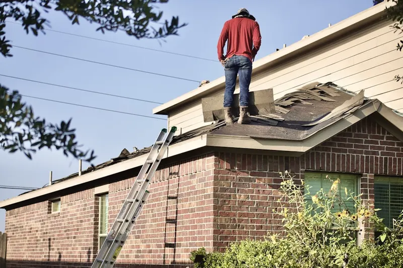 Professional roofer working on a residential roof in Kerrville